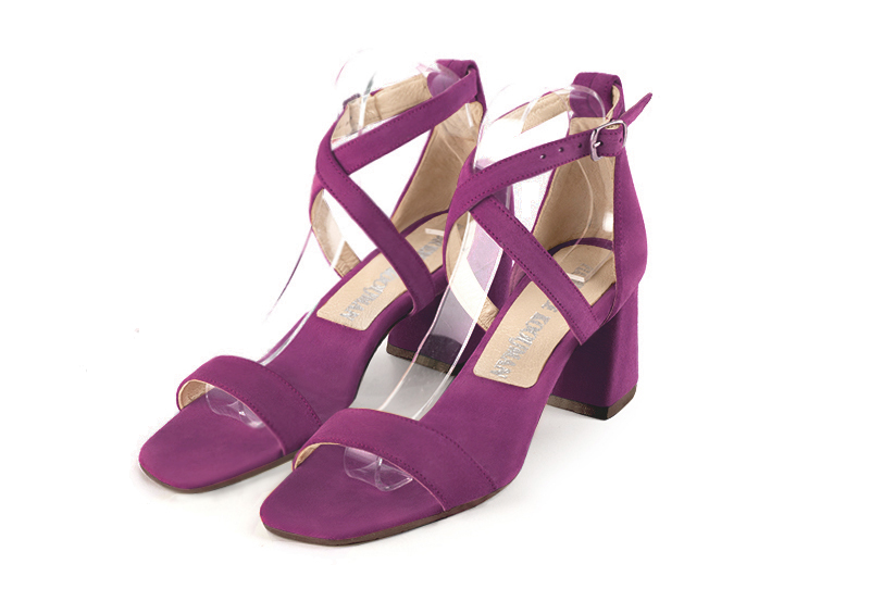  elegant sandals with crossed straps across the instep, closed at the back. . .